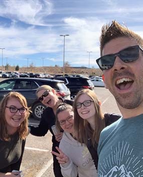 Group selfie in a parking lot