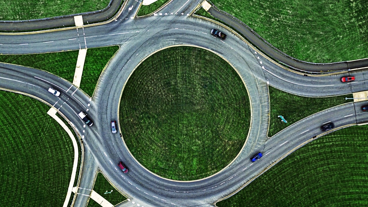 An aerial shot of an interstate with lots of green space around it.